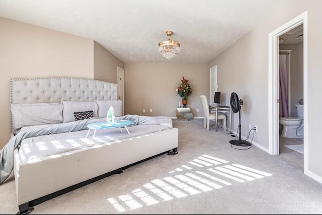 bedroom featuring a chandelier, carpet floors, connected bathroom, and baseboards