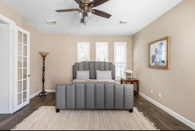 sitting room with visible vents, baseboards, and wood finished floors