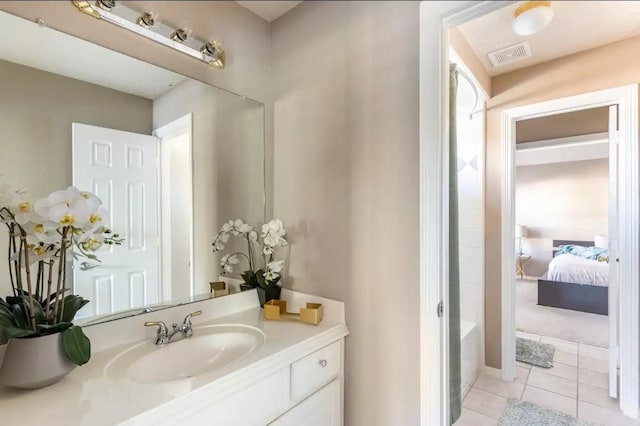 full bath with visible vents, connected bathroom, tile patterned flooring, a washtub, and vanity