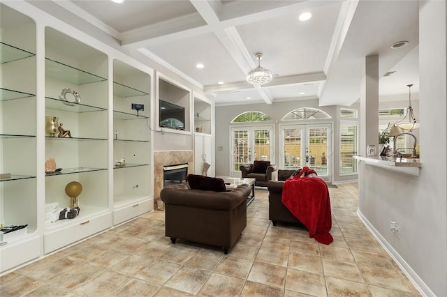 interior space with built in shelves, a tile fireplace, beam ceiling, coffered ceiling, and light tile floors