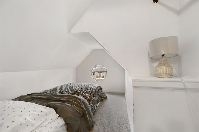 bedroom with carpet flooring and lofted ceiling