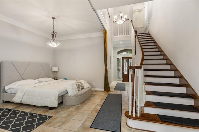 bedroom featuring a chandelier, tile floors, and crown molding