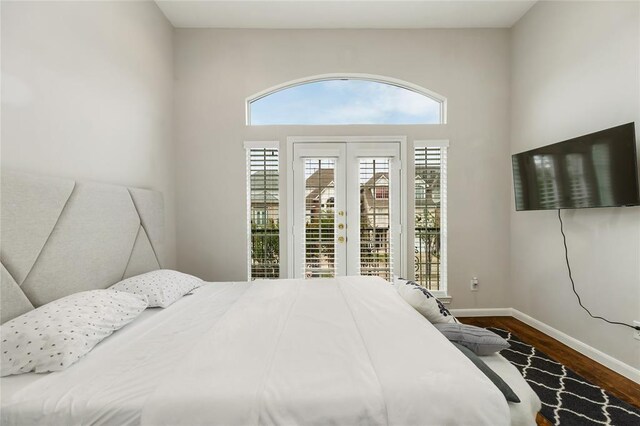 bedroom with baseboards, french doors, wood finished floors, and access to exterior