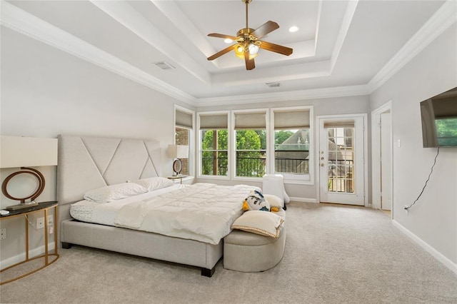 bedroom featuring a tray ceiling, carpet, visible vents, and baseboards