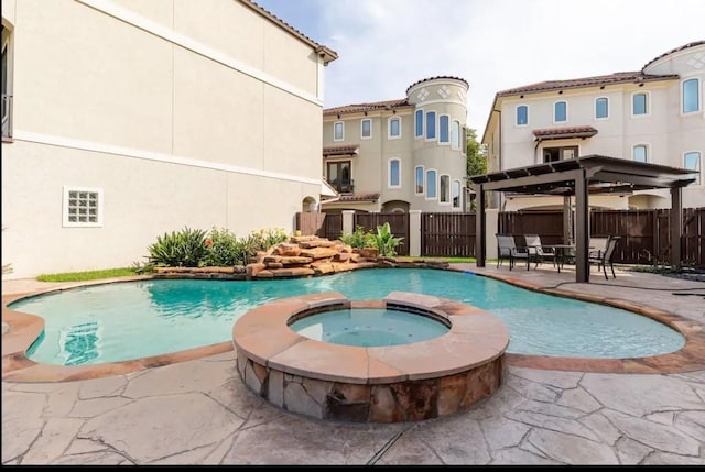 view of swimming pool featuring a patio area and an in ground hot tub