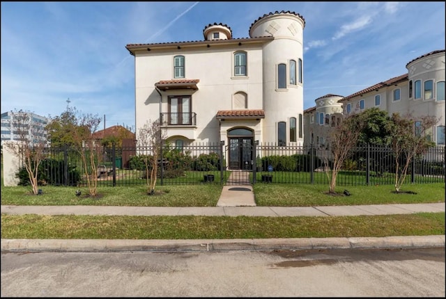 mediterranean / spanish-style home featuring a front yard