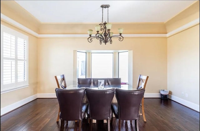 dining space with dark hardwood / wood-style flooring and a chandelier