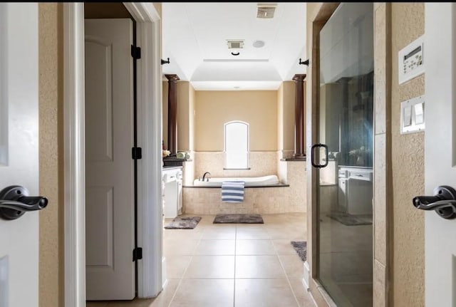 bathroom featuring tile patterned floors, a tray ceiling, and plus walk in shower