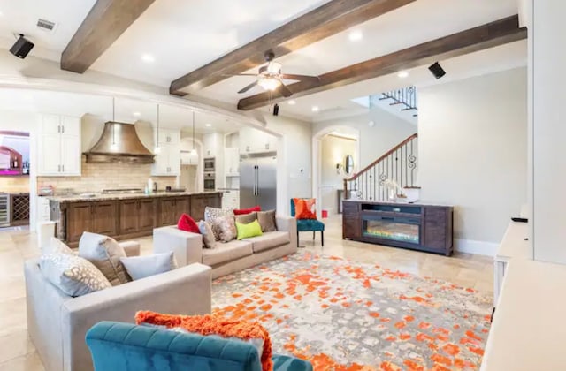 tiled living room with ceiling fan and beam ceiling