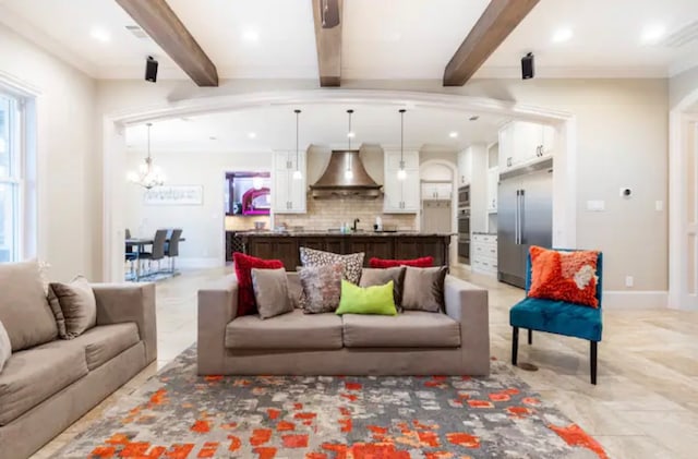 tiled living room featuring beam ceiling, an inviting chandelier, crown molding, and a wealth of natural light