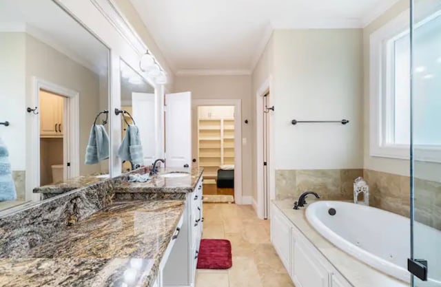 bathroom featuring a bath, tile floors, crown molding, and vanity