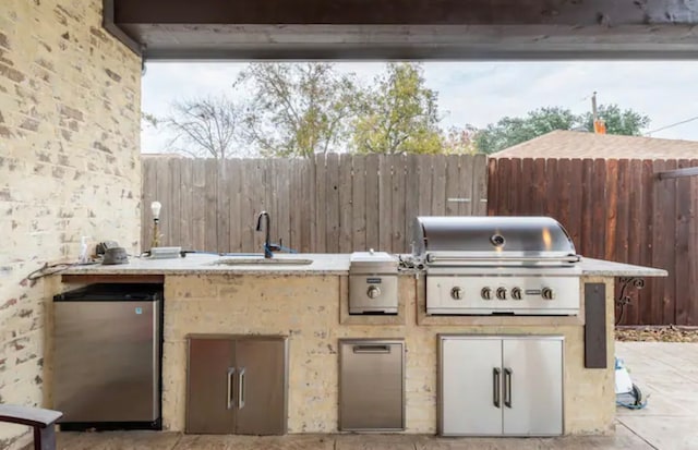 view of terrace featuring grilling area, sink, and exterior kitchen