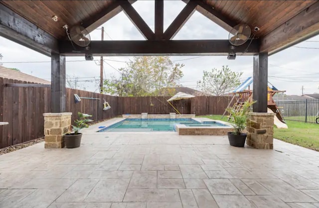 view of swimming pool featuring a patio and an in ground hot tub