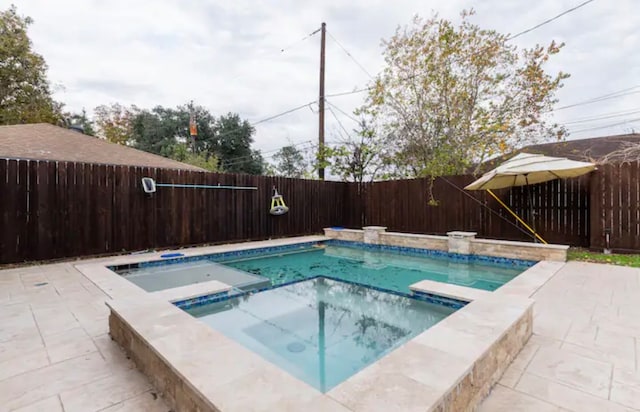 view of swimming pool with an in ground hot tub and a patio