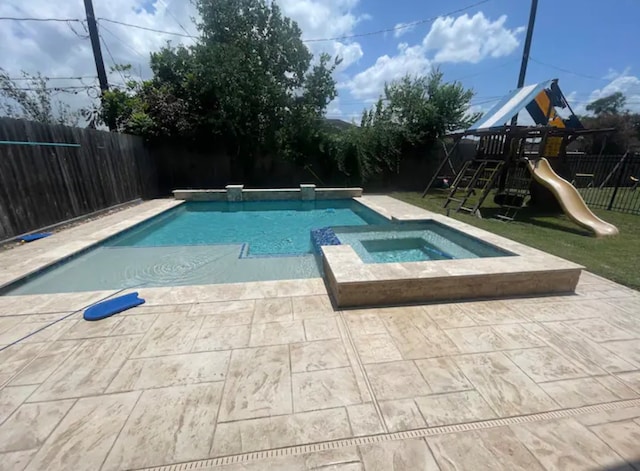 view of pool featuring a patio, a playground, and an in ground hot tub