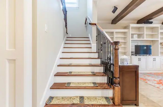 staircase featuring beamed ceiling and tile floors