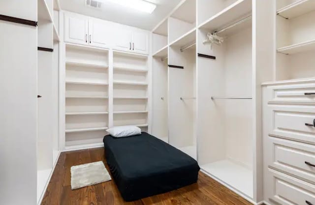 walk in closet with hardwood / wood-style flooring