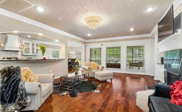 living room featuring crown molding and hardwood / wood-style floors