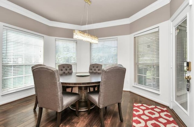 dining room with dark hardwood / wood-style floors, a healthy amount of sunlight, and crown molding