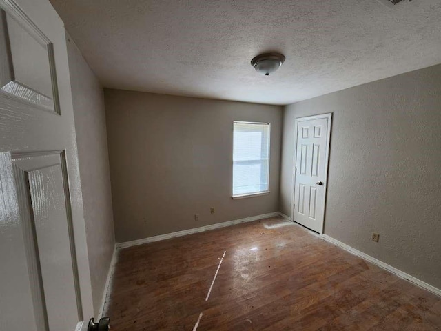 9690 Mapes St, Beaumont, TX 77707 - spare room with hardwood / wood-style flooring and a textured ceiling