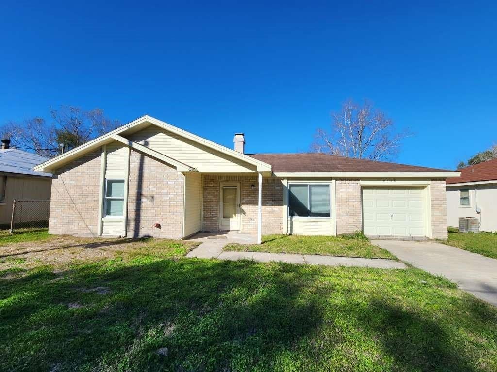 single story home featuring a garage, central AC, and a front lawn