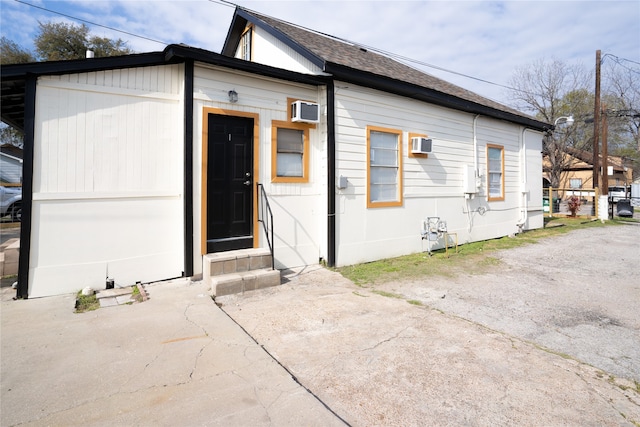 exterior space featuring a wall mounted AC