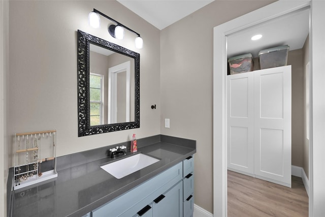 bathroom with hardwood / wood-style flooring and vanity