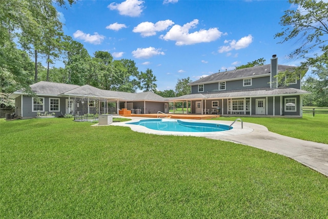 rear view of property with a yard and a patio