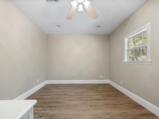 unfurnished room with ceiling fan and wood-type flooring