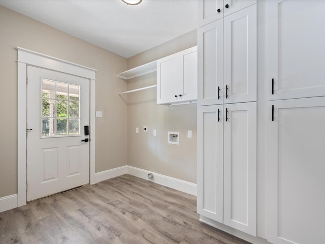 clothes washing area featuring hookup for an electric dryer, hookup for a washing machine, light hardwood / wood-style flooring, and cabinets