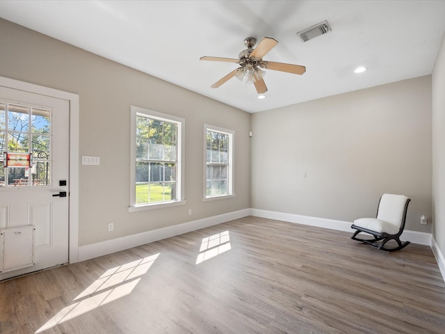 interior space with ceiling fan and light hardwood / wood-style flooring