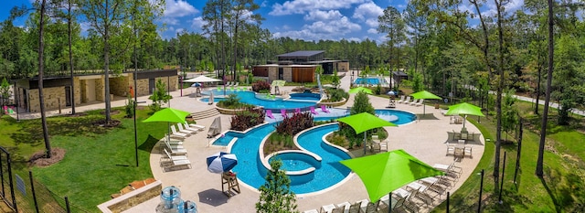 view of swimming pool featuring a yard, a patio, and a jacuzzi