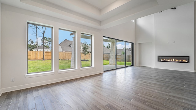 unfurnished living room with a wealth of natural light and hardwood / wood-style floors