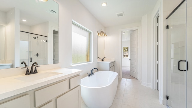 bathroom with vanity, plus walk in shower, and tile patterned flooring