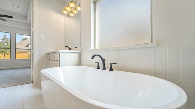 bathroom with vanity, ceiling fan, a washtub, and tile patterned flooring