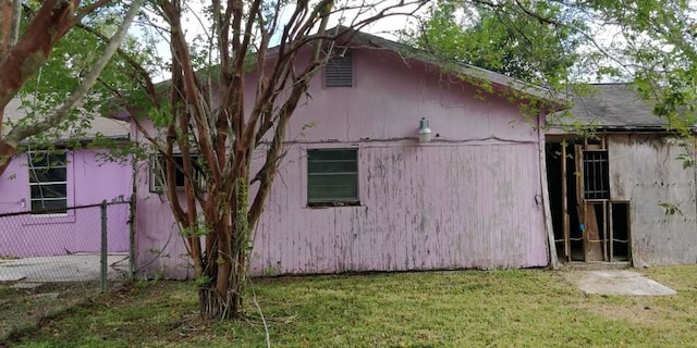 view of property exterior with a yard