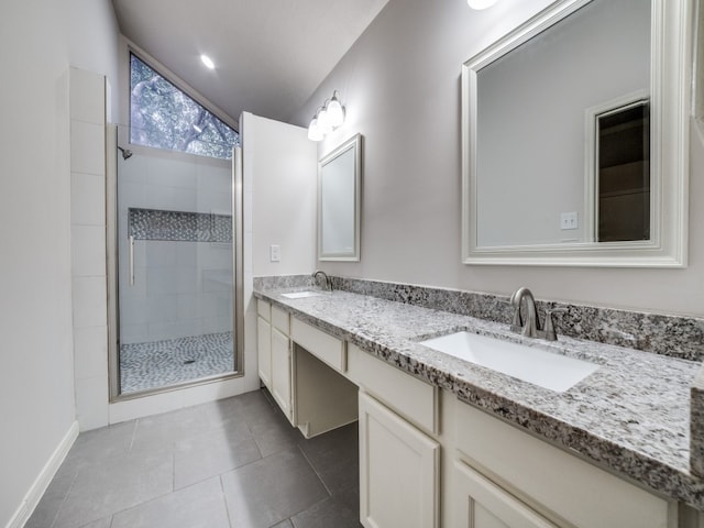 bathroom with lofted ceiling, tile patterned flooring, a shower with door, and vanity