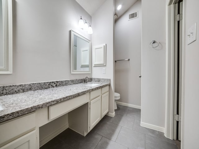 bathroom with vanity, tile patterned flooring, and toilet