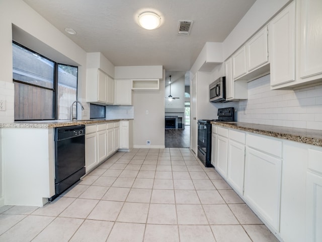 kitchen with white cabinetry, tasteful backsplash, and black appliances