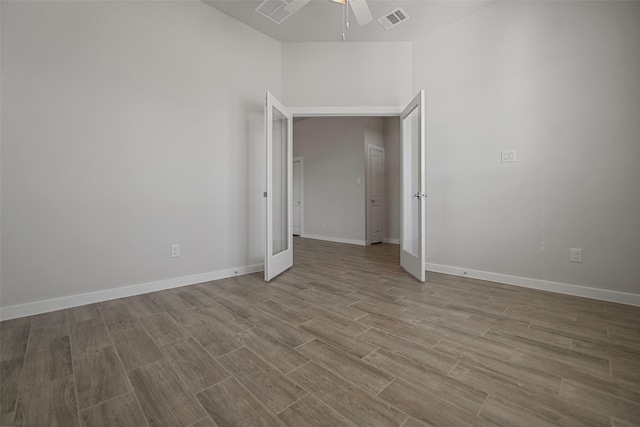 unfurnished room featuring ceiling fan and french doors