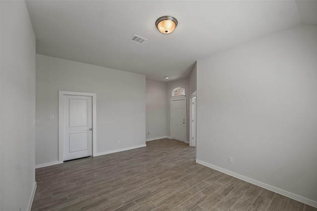 spare room featuring wood-type flooring