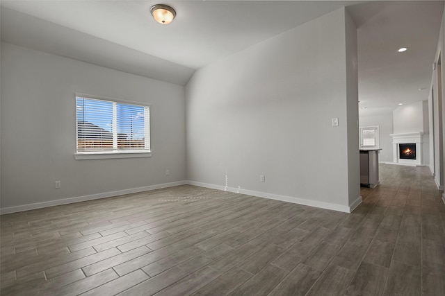 unfurnished room with vaulted ceiling