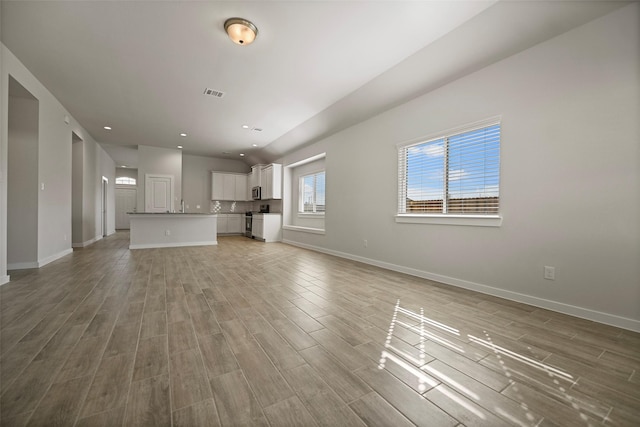 unfurnished living room with light wood-type flooring