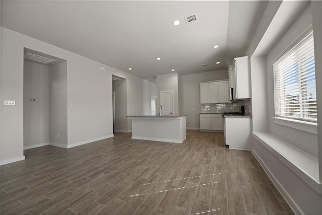 unfurnished living room with dark wood-type flooring