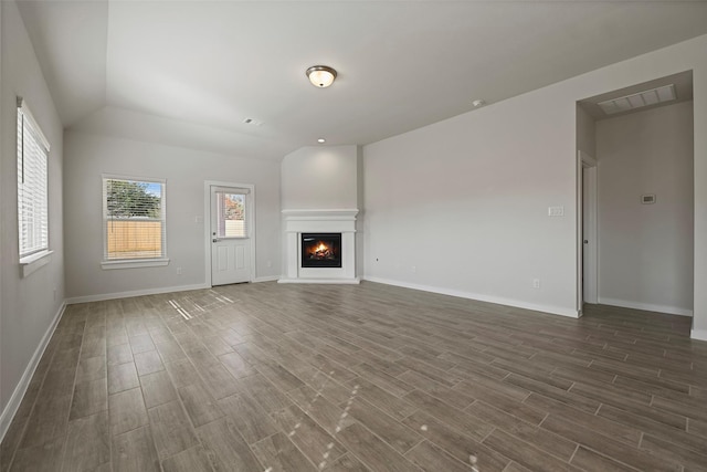 unfurnished living room with lofted ceiling