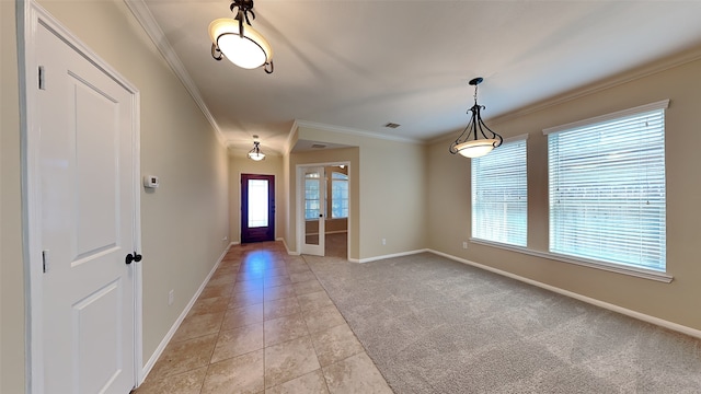 tiled foyer entrance featuring french doors, plenty of natural light, and crown molding