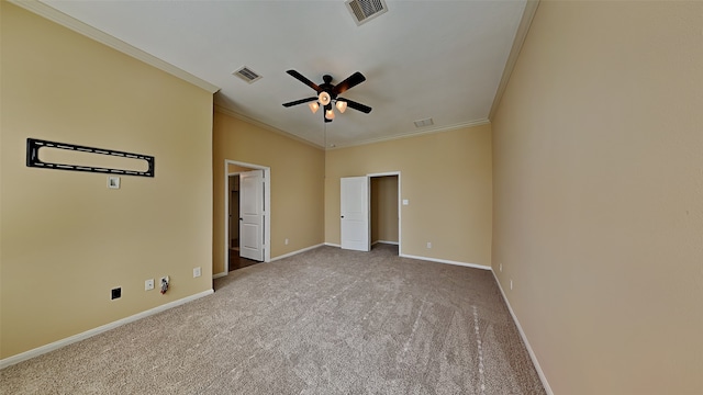 carpeted empty room featuring ceiling fan and crown molding