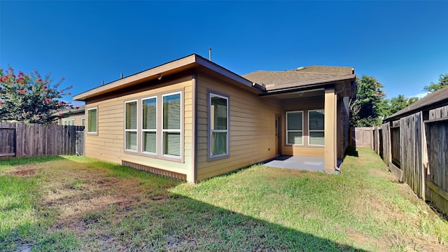 rear view of house with a lawn