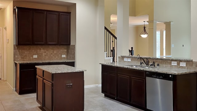 kitchen featuring dishwasher, a center island, sink, hanging light fixtures, and dark brown cabinets