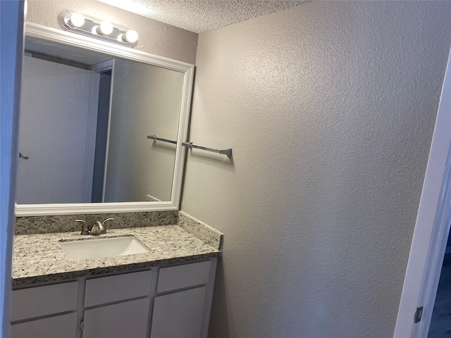 bathroom featuring vanity and a textured ceiling